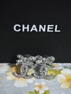 ℒAuthentic CHANEL CC Bow Crystal Stud Earrings, Silver